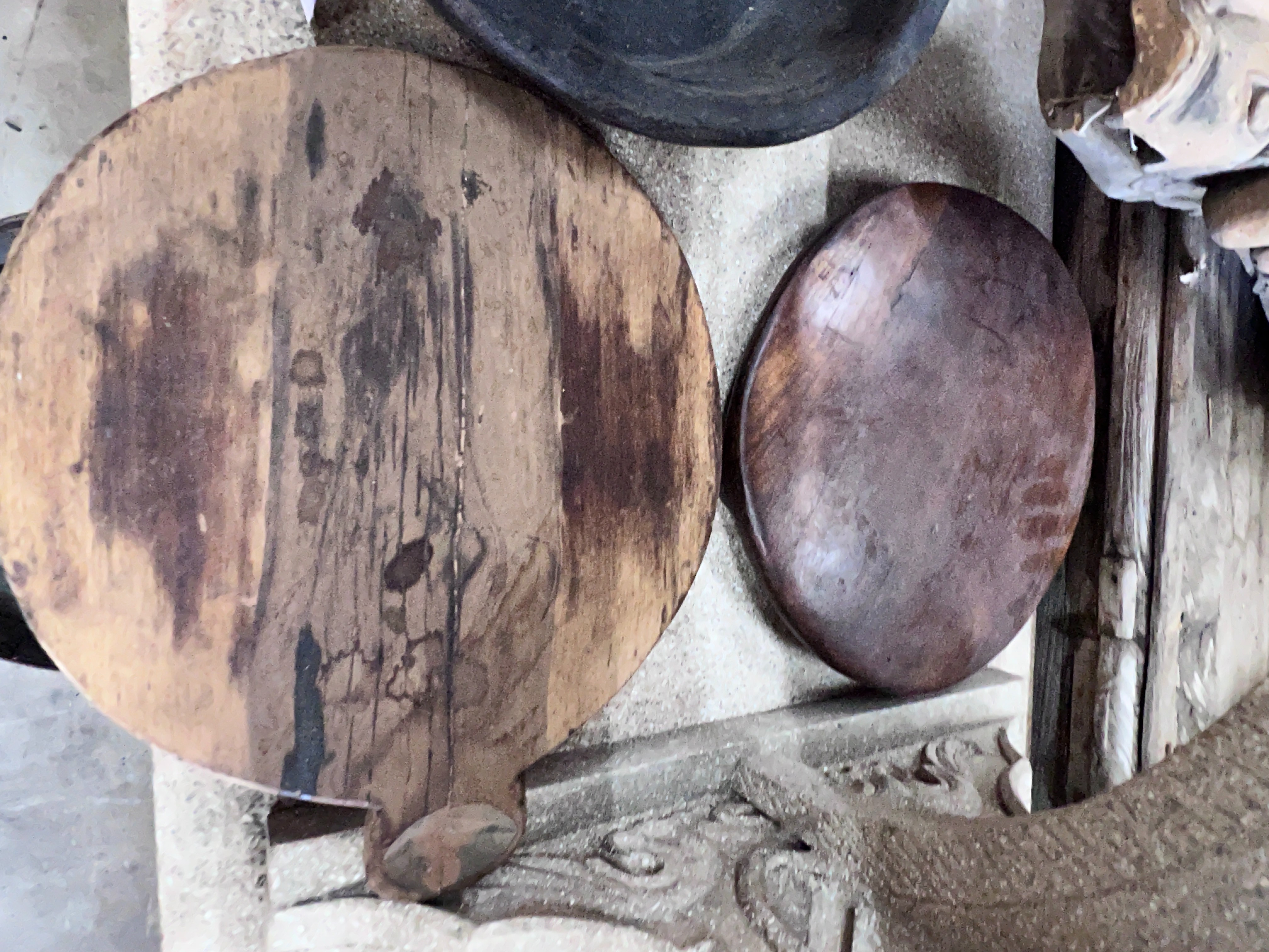 Two wood mazers and five wood trivets, largest diameter 38cm